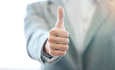 Businessman, hand and thumbs up for approval, success or corporate winning at the office. Hands of man with thumb emoji, yes sign or like for achievement, agreement or thank you at the workplace