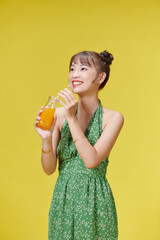 Happy smile asian young woman, girl drinking fresh orange juice in a glass bottle,