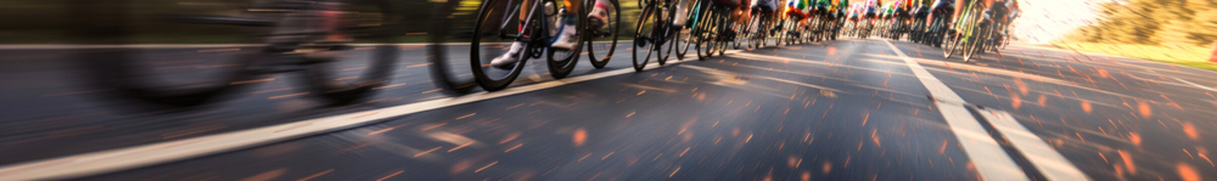 Captivating peloton of cyclists racing at full speed on a road, close-up focus on wheels with dynamic motion blur, evoking adrenaline and determination. Generative AI