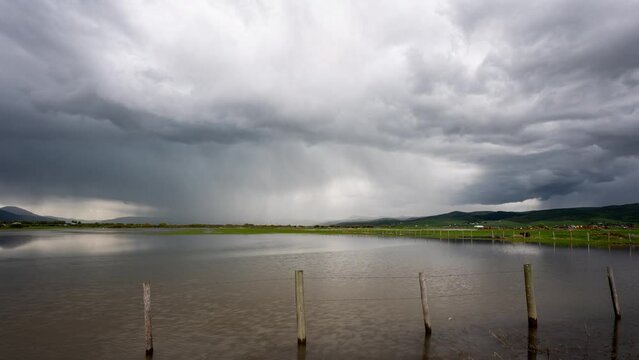 Timelapse of storm with lightning flash over flooded fields in Afton, Wyoming along the Salt River in Star Valley.