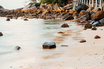 Rocks by the beach in tropical island. Long expsure.