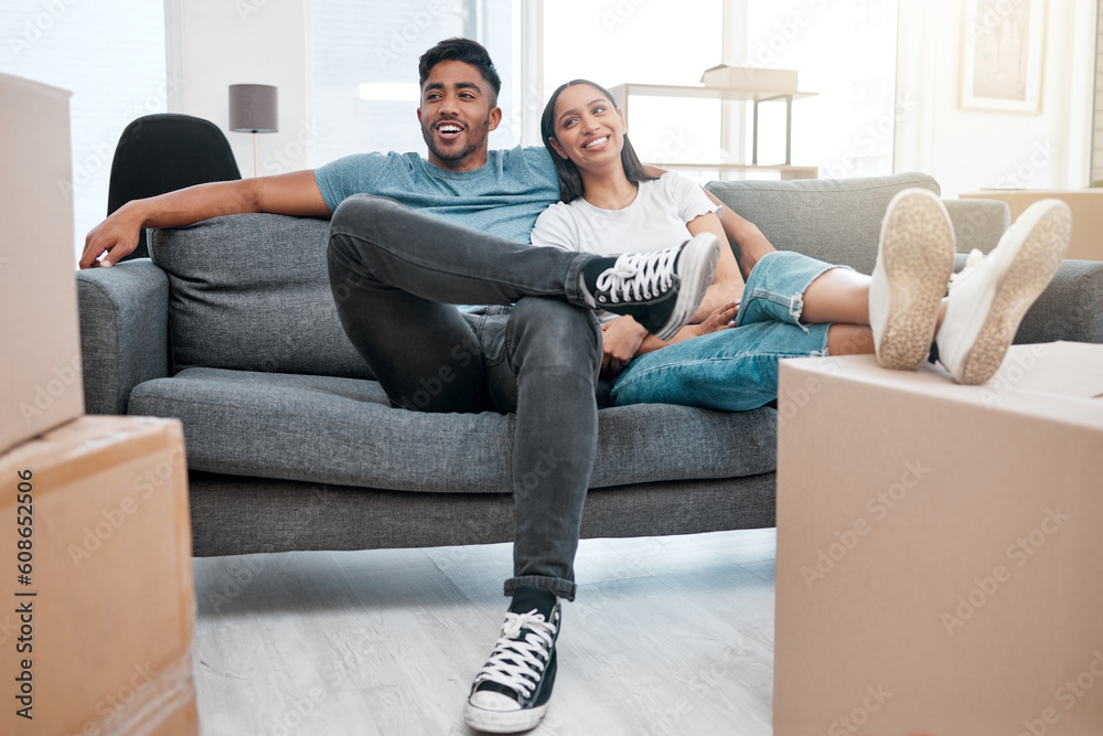 Sticker Homeowners, relax and couple on a sofa, boxes and real estate with property, living room and moving in. Relationship, woman and man on a couch, love and mortgage with happiness, marriage or cardboard