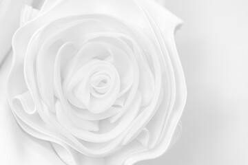 White fabric rose, Details of the bride dress and beautiful embroidery wedding concept used as a background for illustration.