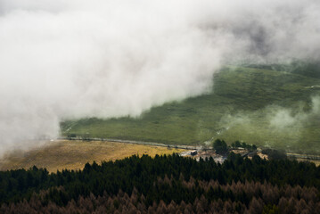 View from Cerenova skala (rock) in West Tatras  in Liptov. Near Liptovsky Mikulas city in foggy weather. Spring time, cloudy weather, Slovakia. Green forest. Village in the fog.