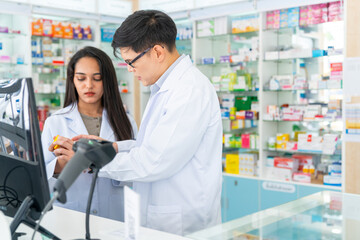 Fototapeta na wymiar Medical pharmacy and healthcare business concept. Asian man and woman pharmacist working on digital tablet together checking medical product, drugs, medicine and supplements in modern drugstore.