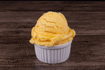 Delicious yellow ice cream served in a white pot. Tasty traditional yellow gelato enjoyed around the world.
