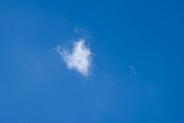 Fototapeta na wymiar Minimal white cloud isolated on blue sky