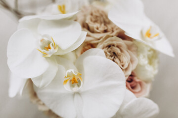 Fototapeta na wymiar Wedding. Details. Bridal bouquet of white flowers with ribbon