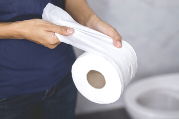 portrait of a woman suffers from diarrhea his stomach painful. ache and problem. hand hold tissue...