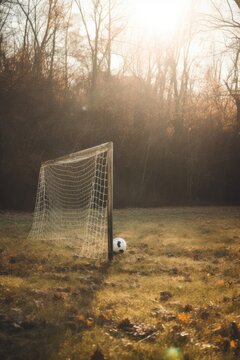 Close up of white and black football in grass in goal, created using generative ai technology