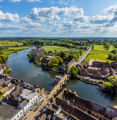 Fototapeta premium An aerial view above the bridge and causeway leading to the town of St Ives, Cambridgeshire in summertime
