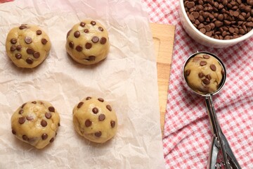Uncooked chocolate chip cookies on cloth, flat lay