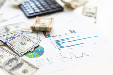 Accounting charts and graphs with us dollar bills pen calculator. Stock market graphs