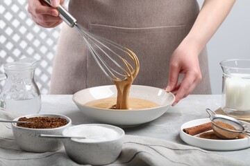 Plakat Woman whipping cream for dalgona coffee at light gray table, closeup