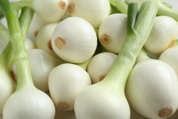 Whole green spring onions as background, closeup