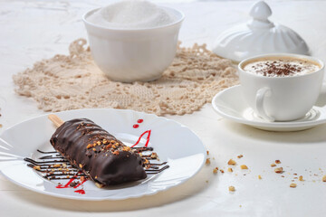 Dessert Cake on a white plate, close-up, selective focus. Cake covered with chocolate and nuts....