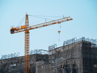 Building under construction, cranes and high-rise building
