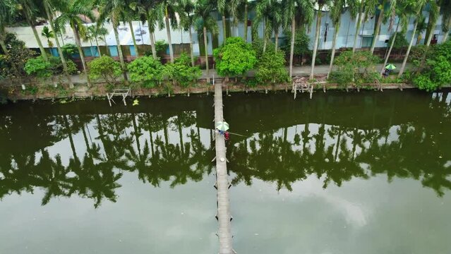 man fishing on a small bridge, aerial view