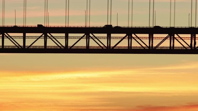 Silhouette of bridge with train at sunset