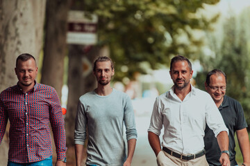 After a productive day at work, a group of diverse colleagues enjoy a leisurely stroll through a...