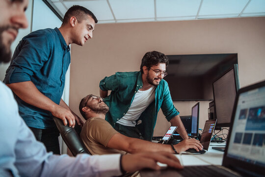 Programmers engrossed in deep collaboration, diligently working together to solve complex problems and develop innovative mobile applications with seamless functionality.