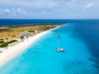 Klein Curacao Island with Tropical Beach at the Caribbean island of Curacao Caribbean, drone aerial view at a beach with turqouse colored ocean and people sunbathing