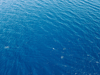 Aerial top down view of sea surface with deep blue water
