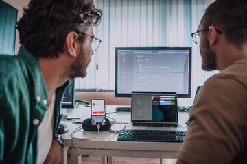 Programmers engrossed in deep collaboration, diligently working together to solve complex problems...