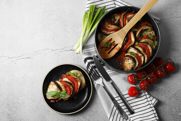 Delicious ratatouille served with basil on light grey table, flat lay. Space for text