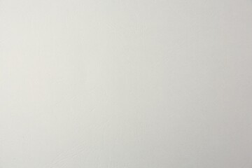 Texture of light grey paper sheet as background, closeup