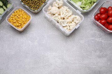 Glass and plastic containers with different fresh products on light grey table, flat lay. Space for text