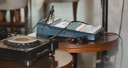 Professional dj equipment on a wooden table in a cafe