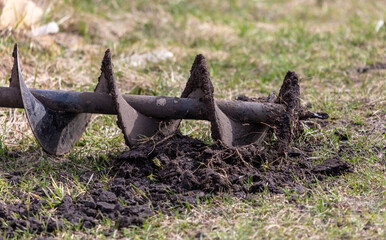 Worker digs the ground with a gasoline blower in the garden