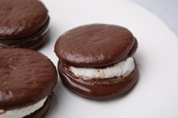 Tasty sweet choco pies on plate, closeup