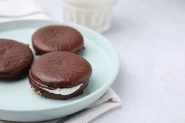 Tasty sweet choco pies on white table, closeup. Space for text