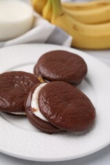 Tasty sweet choco pies on table, closeup