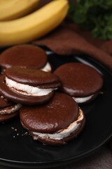 Tasty sweet choco pies on table, closeup