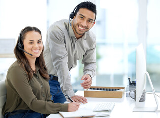 Call center, man coaching woman and smile in portrait, office and writing notes for learning at...
