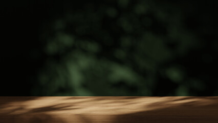 The wooden empty table is on dark texture wall background. Leaves shadow on the wall.