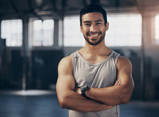 Fitness, smile and portrait of a personal trainer with crossed arms in the gym before a strength workout. Confidence, happy and male athlete after a bodybuilding arm exercise in a sports center.