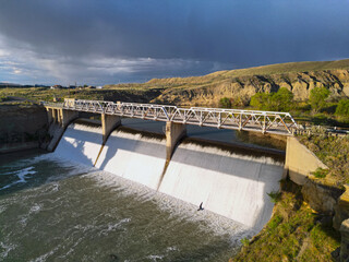 Dam with water flowing down from Shoshone River in Willwood Wyoming with bridge