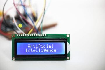 Blue LCD Display displaying the words 'Artificial Intelligence' with a microcontroller and...
