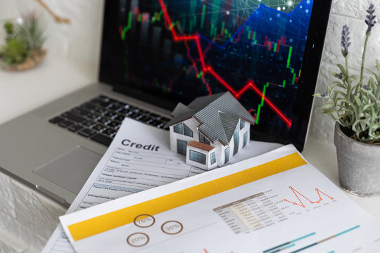 Arrow down and house with money. Falling market price of real estate.