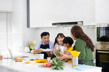Happy family cooking together on kitchen. happy smiling parents enjoy weekend
