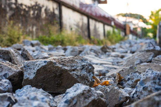 Close-up low-angle view of rubble heaps of broken concrete roads.
