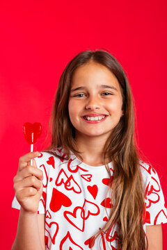 Pretty girl holding red lollipop