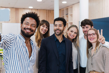 Happy business team posing for a selfie in office