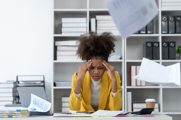 African american businesswoman sitting at desk and busy Showing stress with difficult paperwork in financial business working tax, accounting, statistics and analytic research concept.