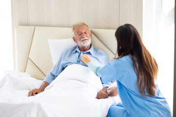 Obraz premium Nurse use stethoscope. Professional caregiver nursing visit elderly patient at home. Nurse assisting senior patient at nursing home.