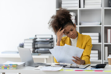 African american businesswoman sitting at desk and busy Showing stress with difficult paperwork in financial business working tax, accounting, statistics and analytic research concept. - obrazy, fototapety, plakaty